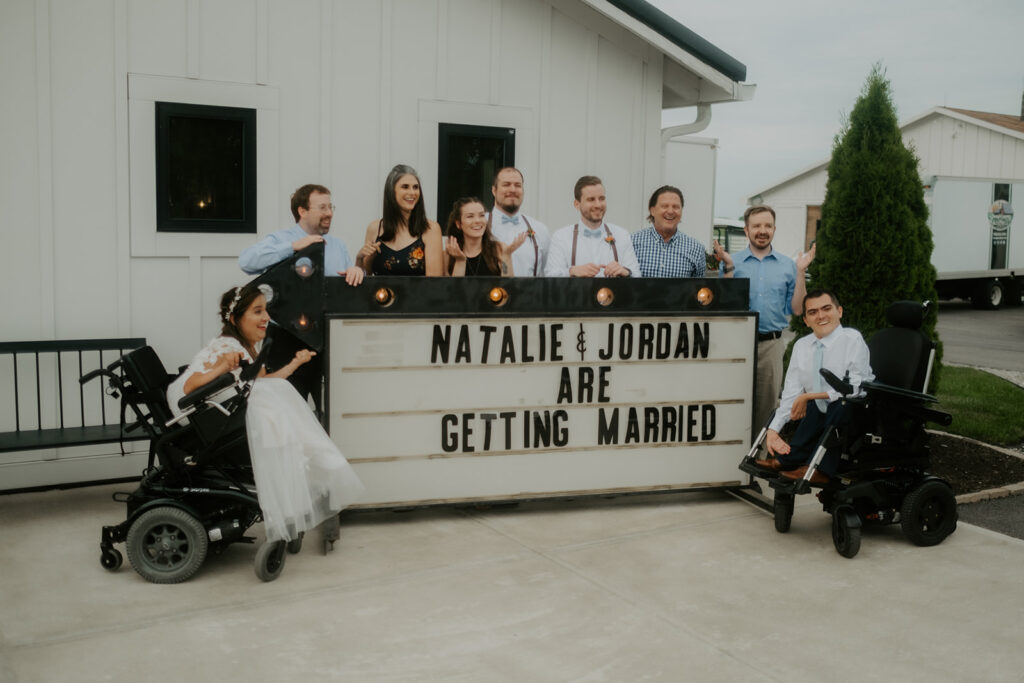 wheelchair wedding with marquee sign