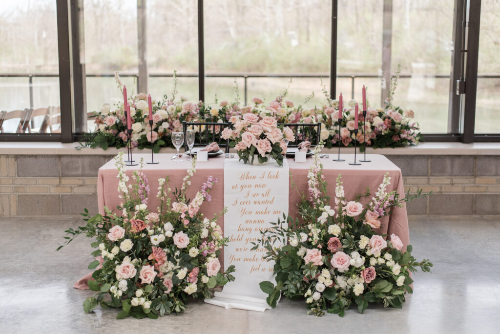 Conservatory at Evergreen wedding head table with script quote tapestry