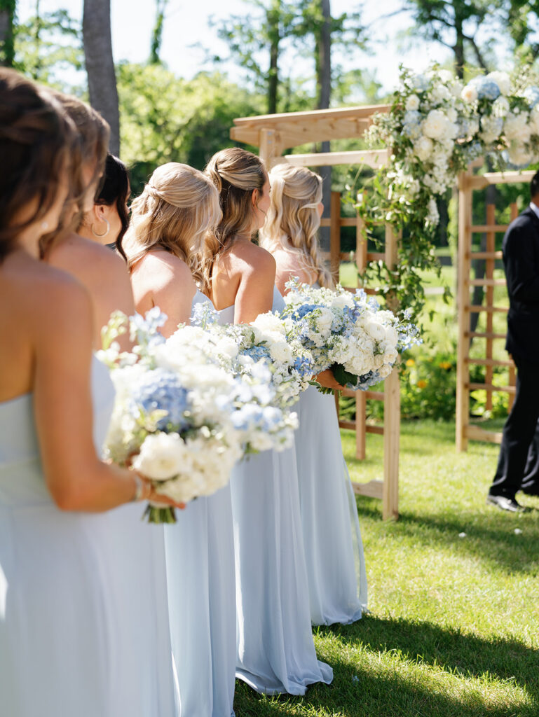 blue and white bridesmaids and bouquets at Holliday Farms