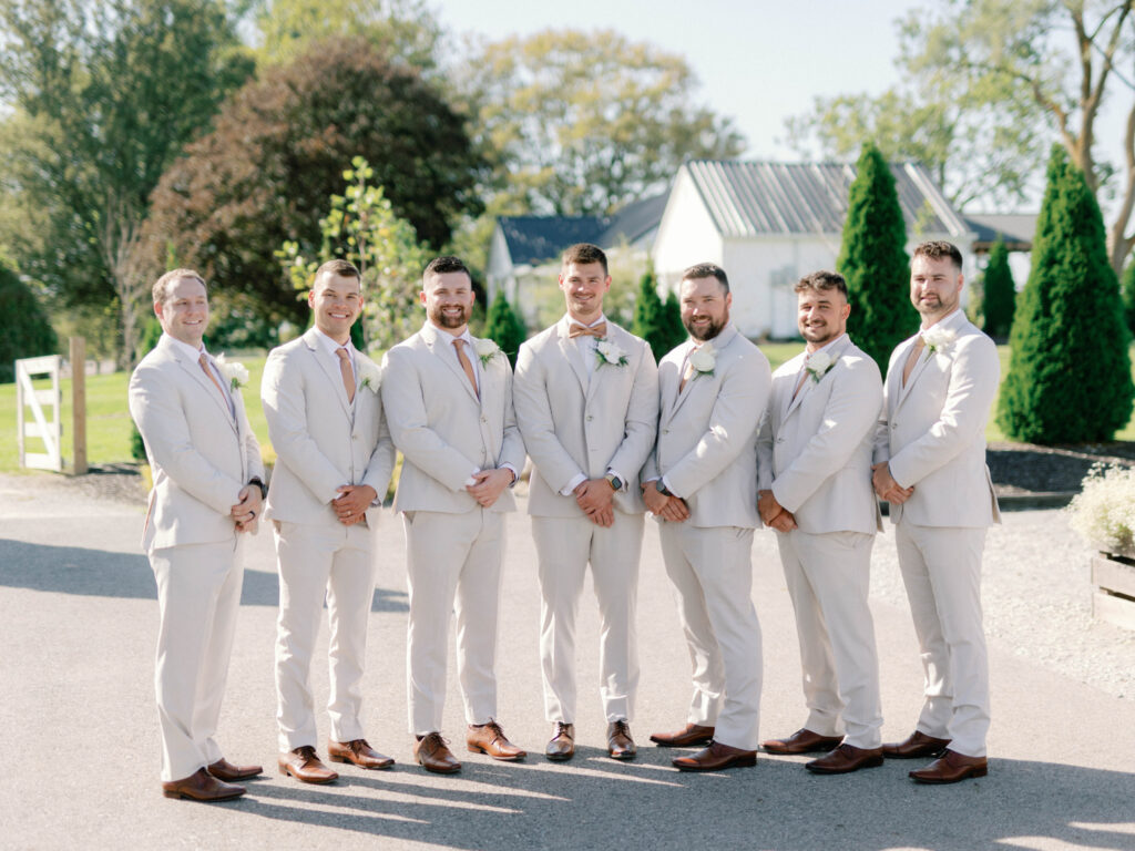 groomsmen in beige khaki suits