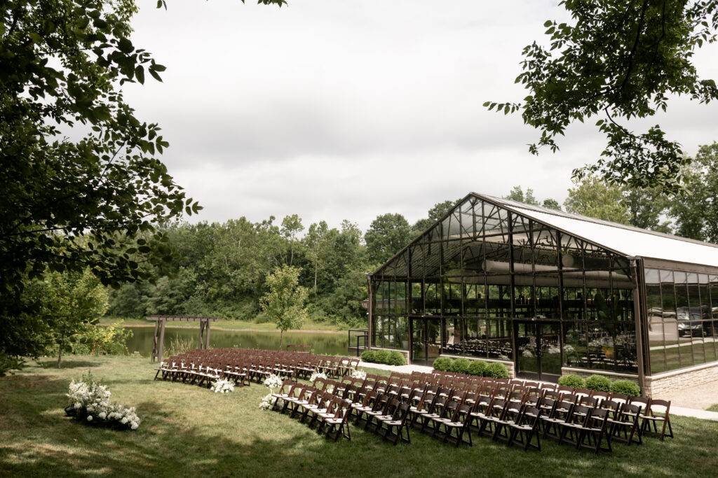 outdoor ceremony at conservatory at evergreen facing the woods